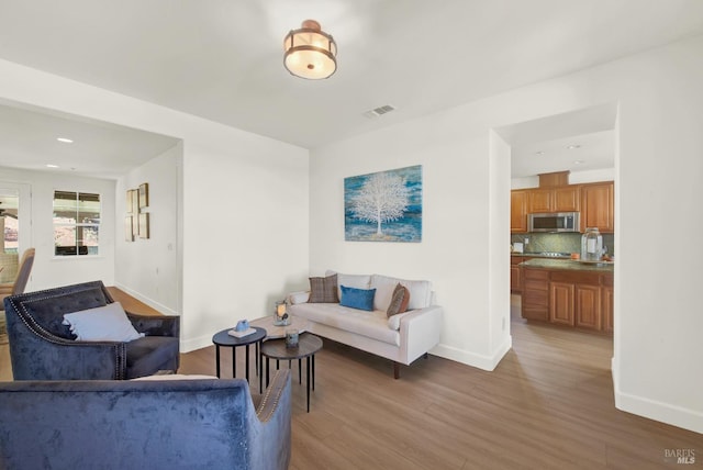 830 Elderberry Loop, Vacaville, CA 95688 - living area with baseboards, visible vents, wood finished floors, and recessed lighting