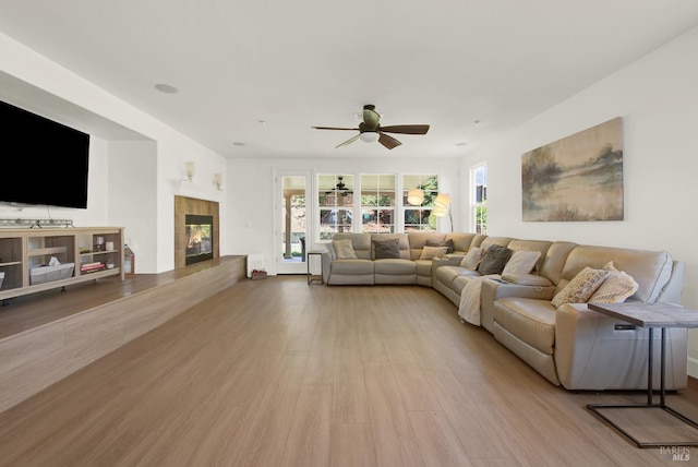 830 Elderberry Loop, Vacaville, CA 95688 - living room with ceiling fan, a tiled fireplace, and wood finished floors