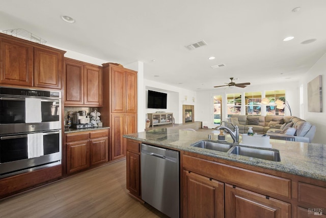 830 Elderberry Loop, Vacaville, CA 95688 - kitchen featuring stone counters, a sink, appliances with stainless steel finishes, and open floor plan