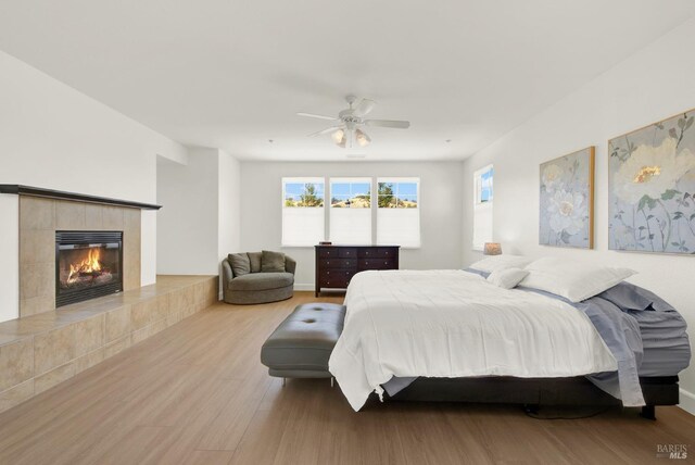 830 Elderberry Loop, Vacaville, CA 95688 - bedroom with a tile fireplace, wood finished floors, and a ceiling fan