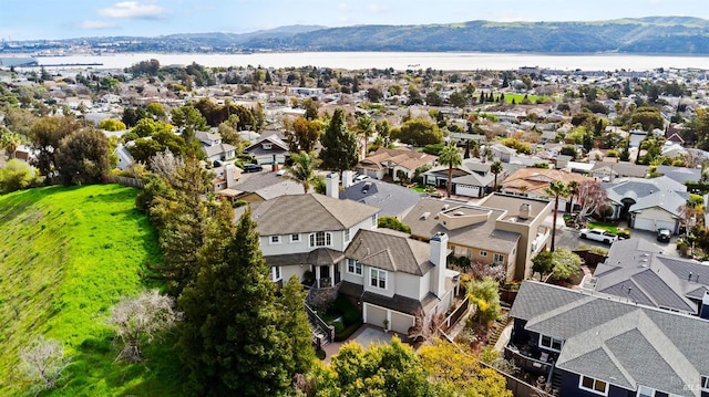 bird's eye view with a residential view and a water and mountain view