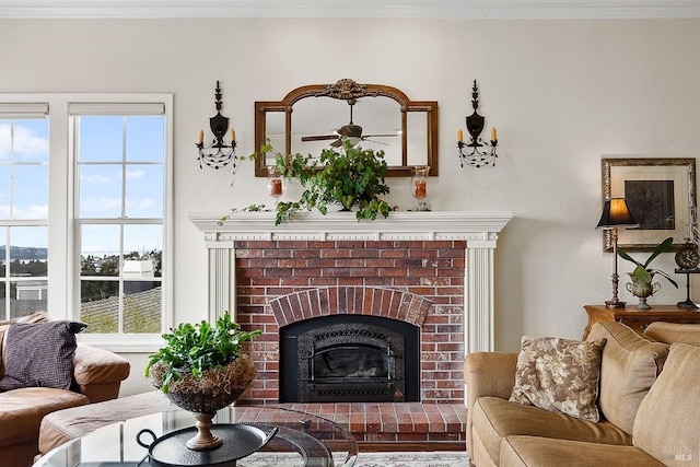 living area featuring ornamental molding and a fireplace