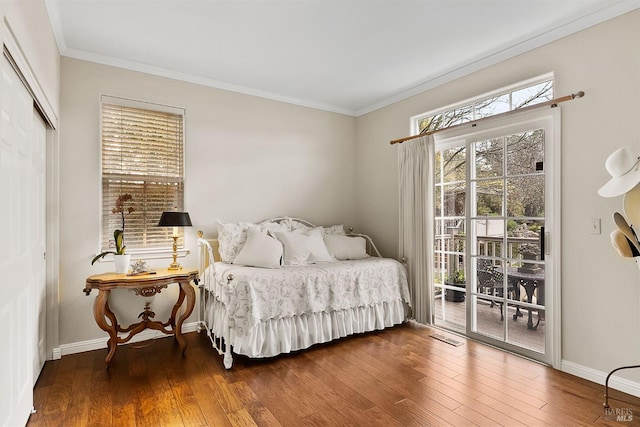 bedroom featuring access to exterior, wood finished floors, and crown molding