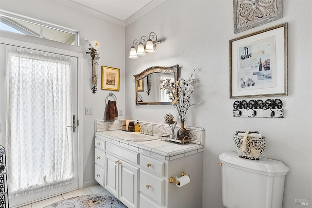 half bath featuring crown molding, vanity, toilet, and tile patterned floors