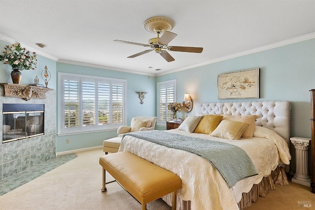 bedroom featuring a tile fireplace, crown molding, a ceiling fan, baseboards, and carpet floors