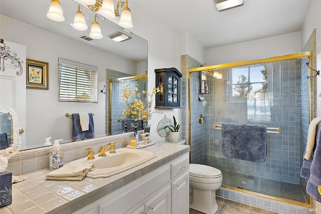 full bathroom with visible vents, a wealth of natural light, a shower stall, and vanity