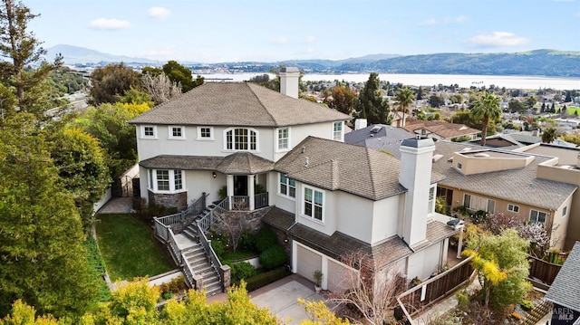 birds eye view of property with a water and mountain view