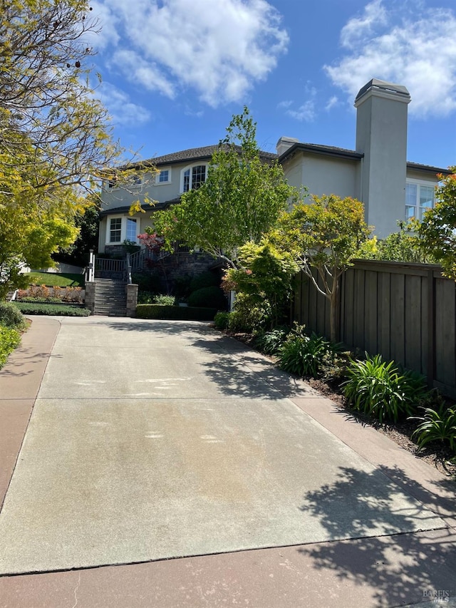 view of front of property featuring fence and stucco siding