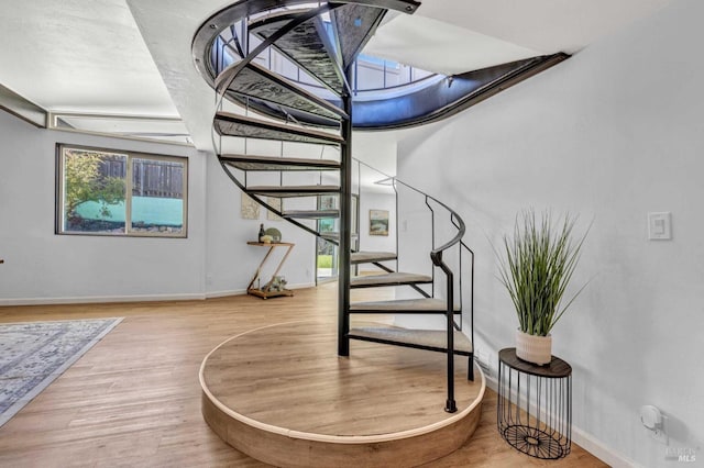 stairway with baseboards and wood finished floors