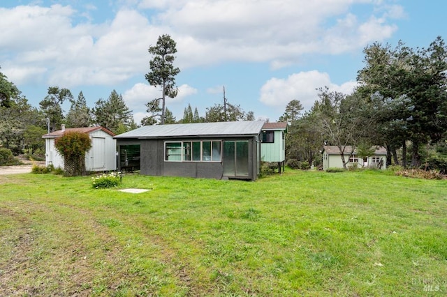 27821 Ten Mile Rd, Point Arena, CA 95468 - back of property with a lawn, an outbuilding, and a storage shed