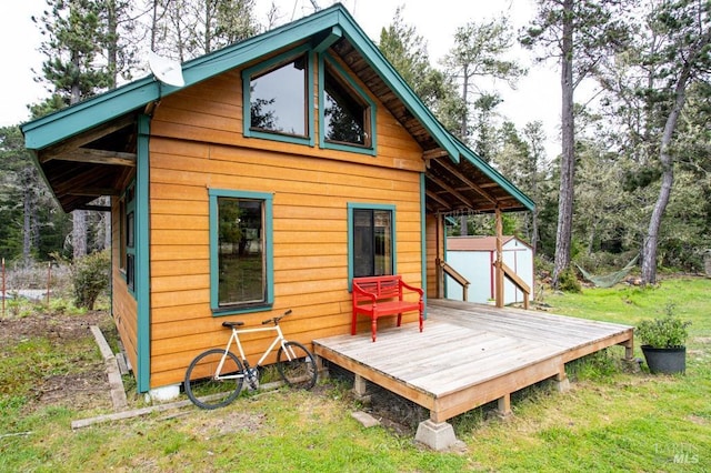27821 Ten Mile Rd, Point Arena, CA 95468 - rear view of house featuring a storage shed, an outbuilding, a yard, and a deck