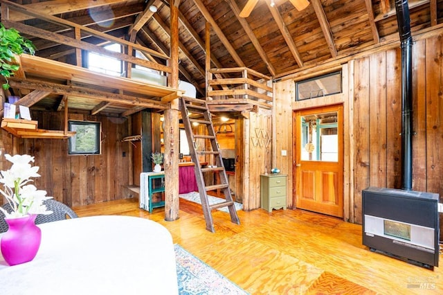 27821 Ten Mile Rd, Point Arena, CA 95468 - bedroom featuring a wood stove, wood walls, wooden ceiling, vaulted ceiling with beams, and wood finished floors