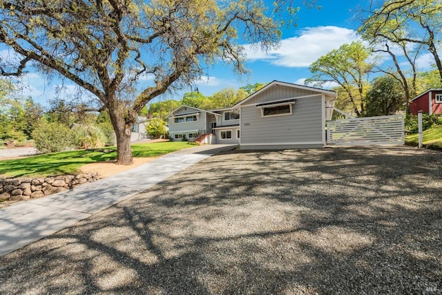 view of front of home featuring fence and concrete driveway