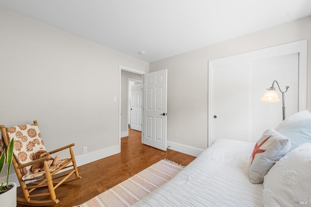 bedroom featuring baseboards and wood finished floors