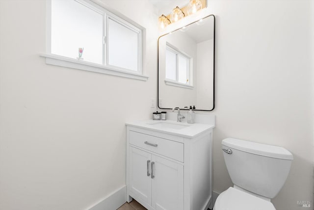 half bathroom with vanity and toilet
