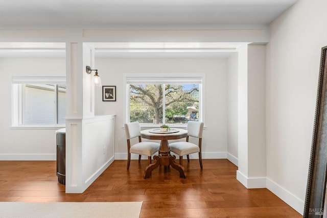 dining room with baseboards and wood finished floors