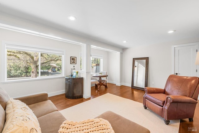 living area with recessed lighting, wood finished floors, and baseboards