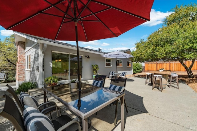 view of patio / terrace with outdoor dining area, outdoor dry bar, and fence