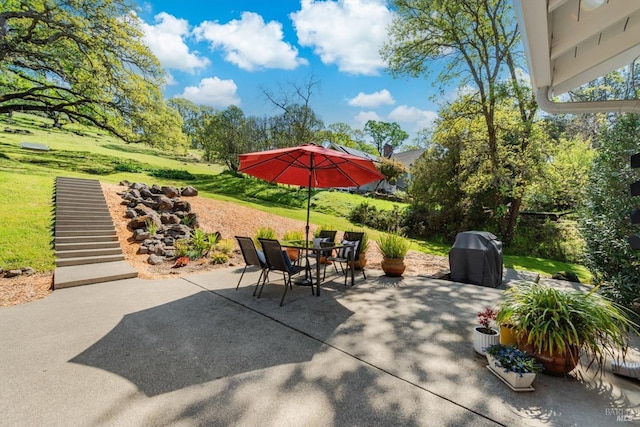 view of patio / terrace with outdoor dining area, stairs, and a grill