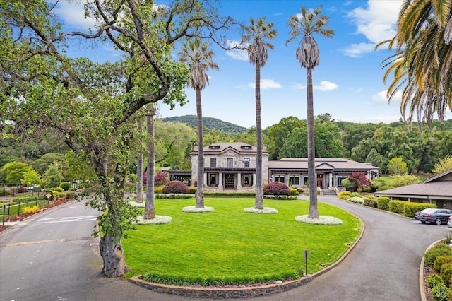 view of home's community featuring a yard and a mountain view