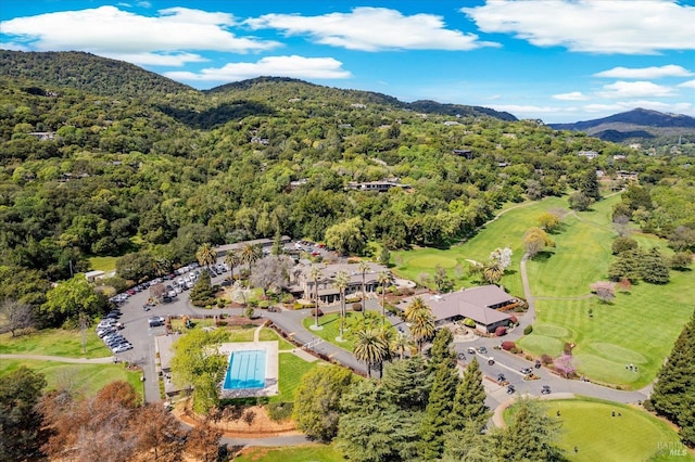 drone / aerial view with view of golf course and a mountain view