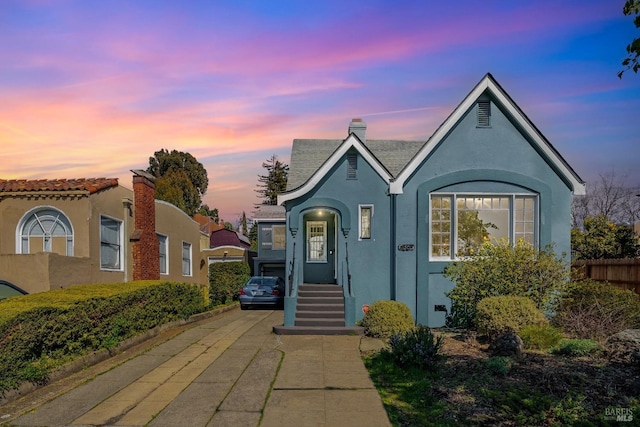 36 Wilson Ave, Vallejo, CA 94590 - view of front of property with stucco siding, a chimney, and driveway