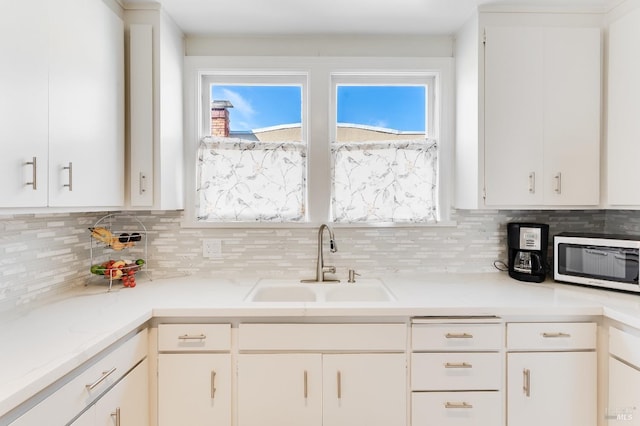 36 Wilson Ave, Vallejo, CA 94590 - kitchen with a wealth of natural light, a sink, backsplash, light countertops, and white cabinets