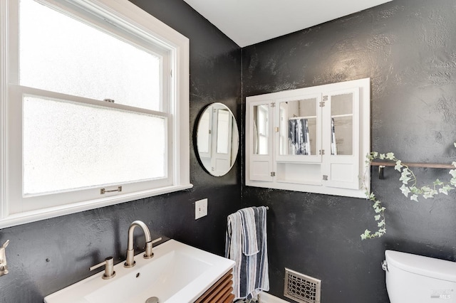 36 Wilson Ave, Vallejo, CA 94590 - bathroom featuring a sink, toilet, a healthy amount of sunlight, and visible vents