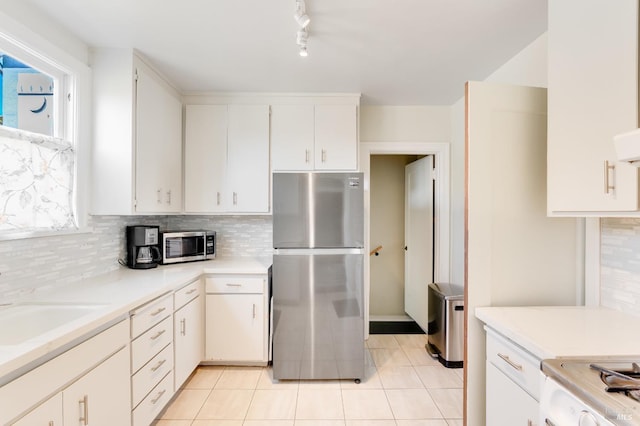 36 Wilson Ave, Vallejo, CA 94590 - kitchen with stainless steel appliances, tasteful backsplash, light countertops, and light tile patterned floors