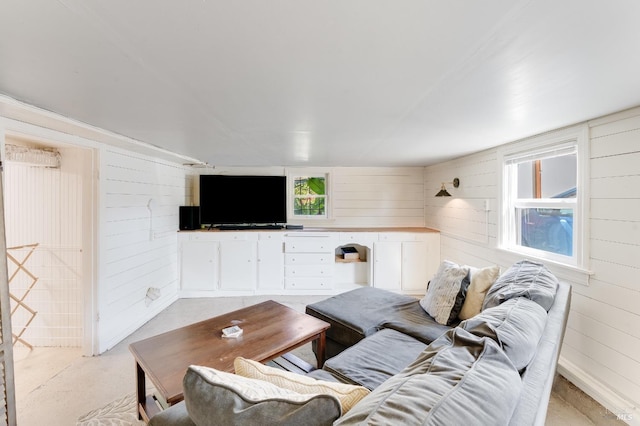 36 Wilson Ave, Vallejo, CA 94590 - living room featuring wood walls, concrete flooring, and plenty of natural light