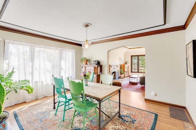 36 Wilson Ave, Vallejo, CA 94590 - dining area featuring ornamental molding, visible vents, light wood finished floors, arched walkways, and baseboards