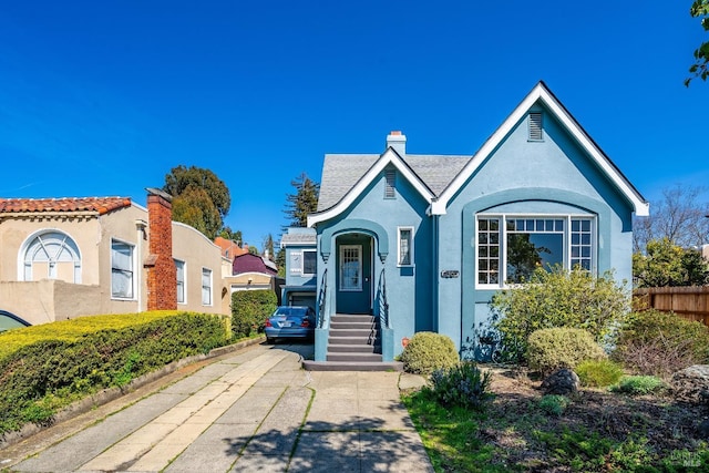 36 Wilson Ave, Vallejo, CA 94590 - view of front of property featuring concrete driveway, stucco siding, a chimney, and fence