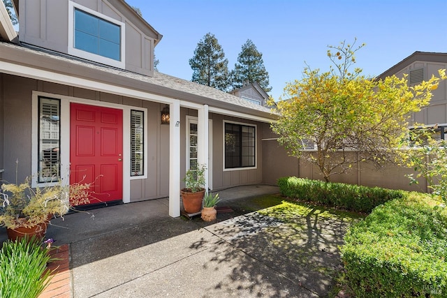 doorway to property featuring a porch and board and batten siding