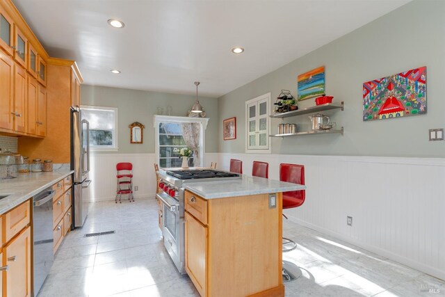 701 W Clay St, Ukiah, CA 95482 - kitchen with a wainscoted wall, a center island, appliances with stainless steel finishes, glass insert cabinets, and a kitchen breakfast bar