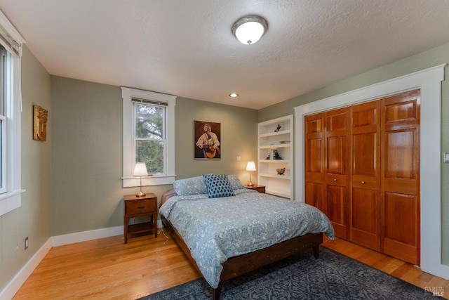701 W Clay St, Ukiah, CA 95482 - bedroom with baseboards, a textured ceiling, a closet, and light wood finished floors