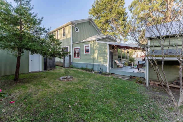 701 W Clay St, Ukiah, CA 95482 - rear view of house featuring a lawn, an outdoor structure, and a fire pit