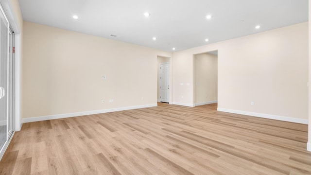 unfurnished room featuring recessed lighting, baseboards, and light wood-style flooring