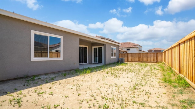 view of yard featuring a fenced backyard and central air condition unit