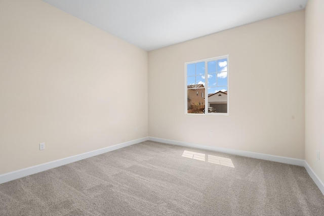 unfurnished room with baseboards and carpet