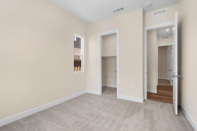 unfurnished bedroom featuring visible vents, baseboards, and carpet floors