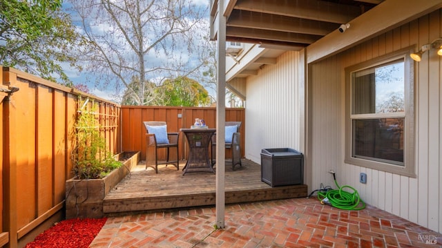 view of patio featuring a fenced backyard and a wooden deck