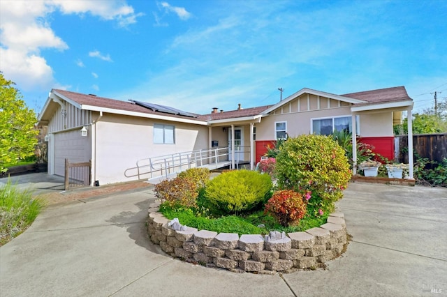 1014 Falcon Dr, Vallejo, CA 94589 - ranch-style home featuring fence, concrete driveway, roof mounted solar panels, stucco siding, and an attached garage