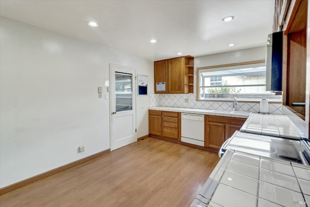 1014 Falcon Dr, Vallejo, CA 94589 - kitchen featuring a sink, tasteful backsplash, tile countertops, light wood-style floors, and white dishwasher