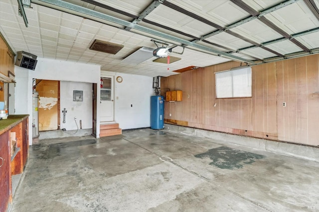 1014 Falcon Dr, Vallejo, CA 94589 - garage featuring a garage door opener, water heater, and wood walls