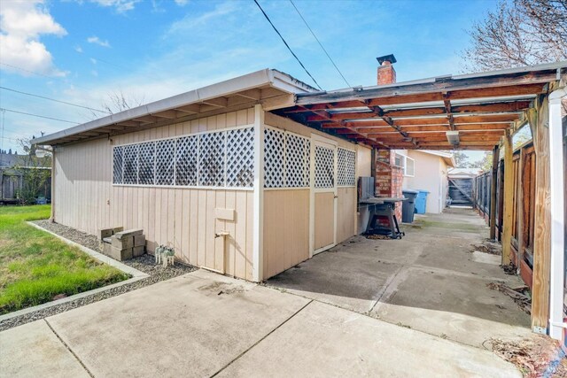 1014 Falcon Dr, Vallejo, CA 94589 - view of side of property with an attached carport, fence, and a chimney