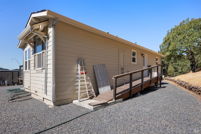 back of property featuring a deck