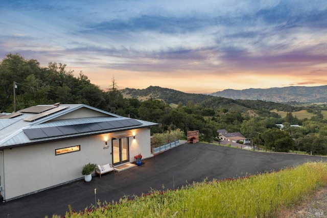 4127 Dry Creek Rd, Napa, CA 94558 - view of front of property with stucco siding, a mountain view, solar panels, and french doors