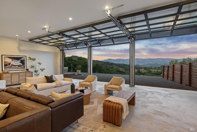 interior space featuring an outdoor living space, a mountain view, and a pergola