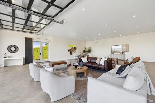 living area featuring french doors, concrete flooring, and recessed lighting
