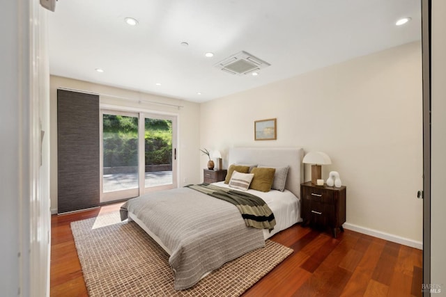 bedroom featuring baseboards, recessed lighting, wood finished floors, and access to exterior